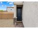 This image shows a stylish front door with stone accents and manicured landscaping at 6611 Dove Point Pl, Las Vegas, NV 89130