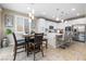 Eat-in kitchen with white cabinets, stainless steel appliances, quartz countertops, and stylish pendant lighting at 6611 Dove Point Pl, Las Vegas, NV 89130