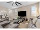 Inviting living room with a large television, comfortable leather seating, stylish decor, and lots of natural light at 6611 Dove Point Pl, Las Vegas, NV 89130
