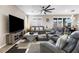 Comfortable living room with modern furniture, a large TV, and plenty of space for relaxation at 6611 Dove Point Pl, Las Vegas, NV 89130