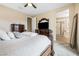 This main bedroom features carpet, an ornate king bed, and neutral walls leading to the ensuite bathroom at 6611 Dove Point Pl, Las Vegas, NV 89130