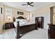 This main bedroom features carpet, an ornate king bed, and neutral walls with a ceiling fan at 6611 Dove Point Pl, Las Vegas, NV 89130