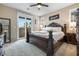 Luxurious main bedroom featuring elegant furniture, and a balcony access at 6611 Dove Point Pl, Las Vegas, NV 89130