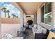 This covered patio features outdoor furniture to relax on and leads to a gravel backyard at 6611 Dove Point Pl, Las Vegas, NV 89130