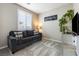 A relaxing sitting room featuring a comfortable sofa, and ample natural light at 6611 Dove Point Pl, Las Vegas, NV 89130