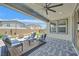 A view of the back porch, with ample seating, a ceiling fan, and a nice tile floor at 6834 Fallen Rock St, North Las Vegas, NV 89084