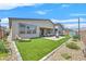 A view of the backyard showcasing the artificial turf, paved patio, and perimeter landscaping at 6834 Fallen Rock St, North Las Vegas, NV 89084