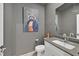 Chic powder room with modern fixtures, a stylish mirror, and unique art at 6834 Fallen Rock St, North Las Vegas, NV 89084