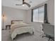 Well-lit secondary bedroom with a ceiling fan, carpet flooring, and a bright window at 6834 Fallen Rock St, North Las Vegas, NV 89084
