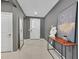 Welcoming entryway boasts neutral paint, tiled flooring, and a modern console table with decorative art at 6834 Fallen Rock St, North Las Vegas, NV 89084