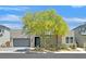Modern home featuring desert landscaping, two-car garage, and stone accents for enhanced curb appeal at 6834 Fallen Rock St, North Las Vegas, NV 89084