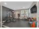 Spacious home gym with state-of-the-art equipment and plenty of natural light at 6834 Fallen Rock St, North Las Vegas, NV 89084