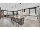 Modern kitchen with a large island, barstool seating, stainless steel appliances, and stylish pendant lighting at 6834 Fallen Rock St, North Las Vegas, NV 89084