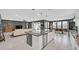 Open-concept kitchen featuring a large island with seating, connecting seamlessly to the living and dining areas at 6834 Fallen Rock St, North Las Vegas, NV 89084