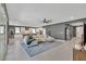 Bright, open-concept living room with ceiling fan and seamless flow to kitchen and dining area at 6834 Fallen Rock St, North Las Vegas, NV 89084