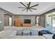 Comfortable living room with a large sectional sofa, glass coffee table, and access to outdoor space at 6834 Fallen Rock St, North Las Vegas, NV 89084