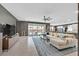 Spacious living room with stylish decor, large windows, and a seamless flow to the outdoor patio at 6834 Fallen Rock St, North Las Vegas, NV 89084