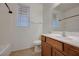 Bathroom features a wooden vanity, white toilet, and shower and tub combo at 6844 Tropicaire St, Las Vegas, NV 89149
