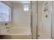 Close up of bright bathroom featuring bathtub and glass shower enclosure at 6844 Tropicaire St, Las Vegas, NV 89149