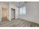 Bright bedroom features wood-look flooring, a ceiling fan, and a closet with sliding doors at 6844 Tropicaire St, Las Vegas, NV 89149