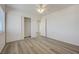 Bright bedroom features wood-look flooring, a ceiling fan, and a closet with sliding doors at 6844 Tropicaire St, Las Vegas, NV 89149