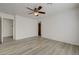 Bright bedroom features wood-look floors, ceiling fan, and ensuite access at 6844 Tropicaire St, Las Vegas, NV 89149