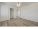 Bright bedroom features wood-look flooring, a ceiling fan, and a closet with sliding doors at 6844 Tropicaire St, Las Vegas, NV 89149