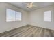 Bright bedroom with wood-look floors, modern ceiling fan, and plenty of natural light at 6844 Tropicaire St, Las Vegas, NV 89149