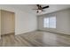 Bedroom with wood look floors, ceiling fan, and window with blinds at 6844 Tropicaire St, Las Vegas, NV 89149