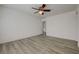 Bright bedroom features wood-look floors, ceiling fan, and ensuite access at 6844 Tropicaire St, Las Vegas, NV 89149