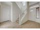 Bright entryway featuring tile floors, stairs to the second floor, and a white front door with decorative glass at 6844 Tropicaire St, Las Vegas, NV 89149
