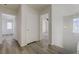 Hallway with wood look flooring, light fixture, and doorways to bedrooms at 6844 Tropicaire St, Las Vegas, NV 89149