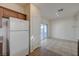 Kitchen with adjacent dining area featuring tile flooring, white appliances, and plenty of space to entertain at 6844 Tropicaire St, Las Vegas, NV 89149