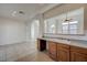 Open concept design featuring the kitchen with warm wood cabinetry and a view into the dining area at 6844 Tropicaire St, Las Vegas, NV 89149