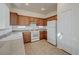 Practical kitchen features wood cabinets, white appliances, and plenty of counter space, perfect for the home chef at 6844 Tropicaire St, Las Vegas, NV 89149