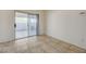 The empty living space is filled with tile flooring, and sliding doors out to the patio at 6844 Tropicaire St, Las Vegas, NV 89149