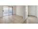 An empty living area boasts tile flooring and sliding glass doors to a patio at 6844 Tropicaire St, Las Vegas, NV 89149