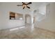Open-concept living area with tiled floors and views of the kitchen and staircase at 6844 Tropicaire St, Las Vegas, NV 89149