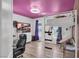 A cozy bedroom with a loft bed, wooden floors, and a purple ceiling offers unique charm at 7194 Clear Range Ave, Las Vegas, NV 89178