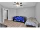 Comfortable bedroom with natural light, wood-like flooring, and a ceiling fan, ideal for relaxation at 7194 Clear Range Ave, Las Vegas, NV 89178