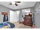 Comfortable bedroom with wood floors, a ceiling fan, and a view of the closet at 7194 Clear Range Ave, Las Vegas, NV 89178
