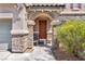 Close up of the entryway with decorative stone pillars and tile roof at 7194 Clear Range Ave, Las Vegas, NV 89178