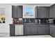 Well-equipped kitchen with stainless steel dishwasher and a black granite countertop at 7194 Clear Range Ave, Las Vegas, NV 89178