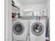 Convenient laundry room featuring a washer, dryer, and shelving, making laundry chores a breeze at 7194 Clear Range Ave, Las Vegas, NV 89178