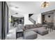 Open-concept living room with tile floors, modern lighting, and a stylish bar area, perfect for entertaining at 7194 Clear Range Ave, Las Vegas, NV 89178