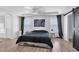 Spacious main bedroom features a barn door, two windows, and a modern aesthetic for relaxation at 7194 Clear Range Ave, Las Vegas, NV 89178