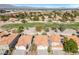 Overhead shot of a suburban neighborhood near a golf course, highlighting the uniformity and neat arrangement of houses at 7460 Desert Flame Ct, Las Vegas, NV 89149