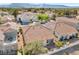 Aerial view of the home highlighting the tile roof, private patio, and surrounding neighborhood at 7460 Desert Flame Ct, Las Vegas, NV 89149