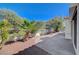 Backyard patio area with privacy wall, desert landscaping and tranquil ambience at 7460 Desert Flame Ct, Las Vegas, NV 89149
