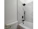 This bathroom features marble-style shower tiles and modern black hardware at 7460 Desert Flame Ct, Las Vegas, NV 89149